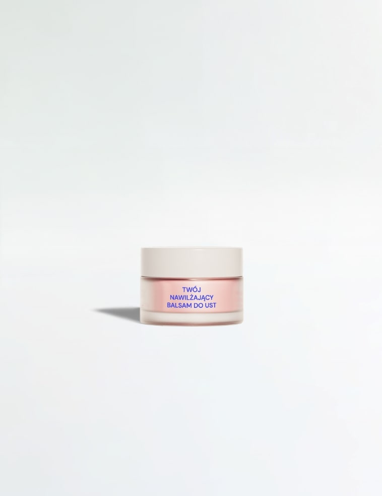 Szklany słoik zawierający nawilżający balsam do ust.